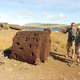 Researchers examine a pukao near the statue platform.